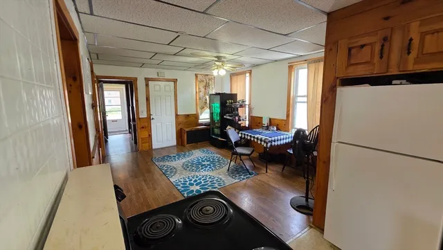 a hallway with furniture and a potted plant