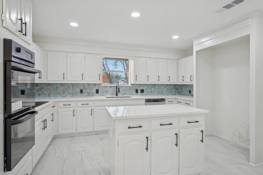 62 Legend Road Benbrook, TX 76132 - Photo 10 of 27 Wonderful island kitchen equipped with premium appliances, designer finishes, abundance of cabinets and counter space plus a walk-in pantry.