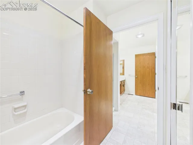 a view of a room with wooden floor