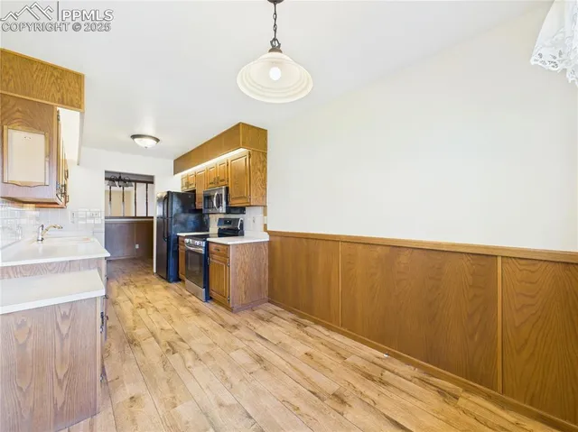 a kitchen with stainless steel appliances granite countertop a refrigerator and a stove top oven