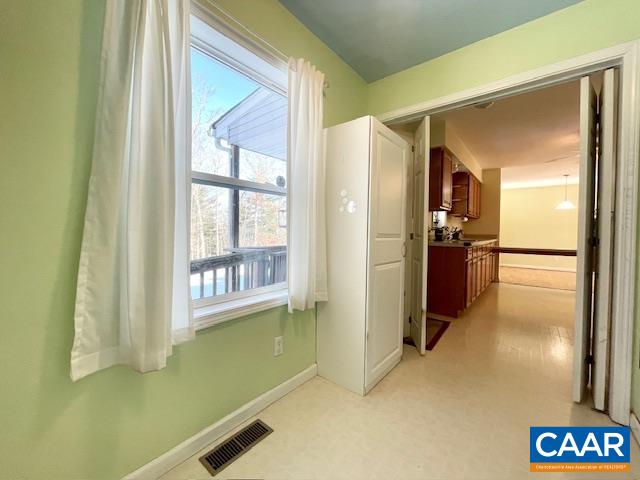 4785 Woodbound Road Keswick, VA 22947 - Photo 15 of 36 a view of a kitchen with a refrigerator and a window