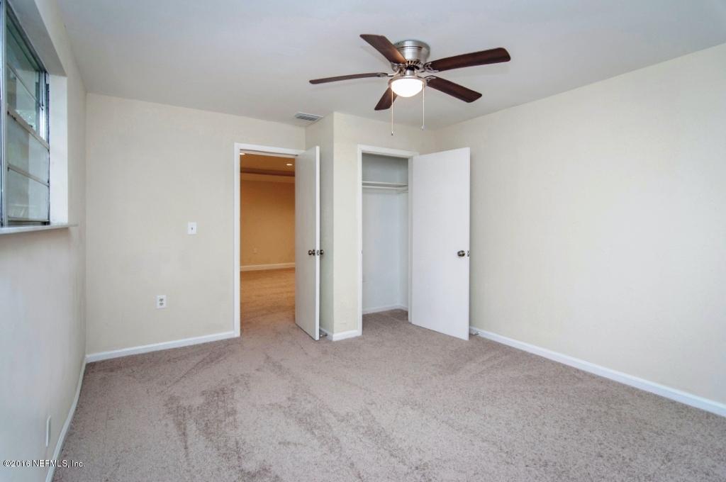 1944 Constant Drive Jacksonville, FL 32210 - Photo 17 of 21 an empty room with closet and a ceiling fan