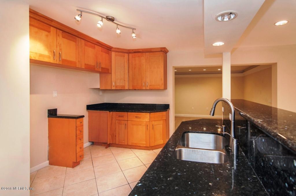 1944 Constant Drive Jacksonville, FL 32210 - Photo 9 of 21 a kitchen with stainless steel appliances granite countertop a sink a stove and a refrigerator