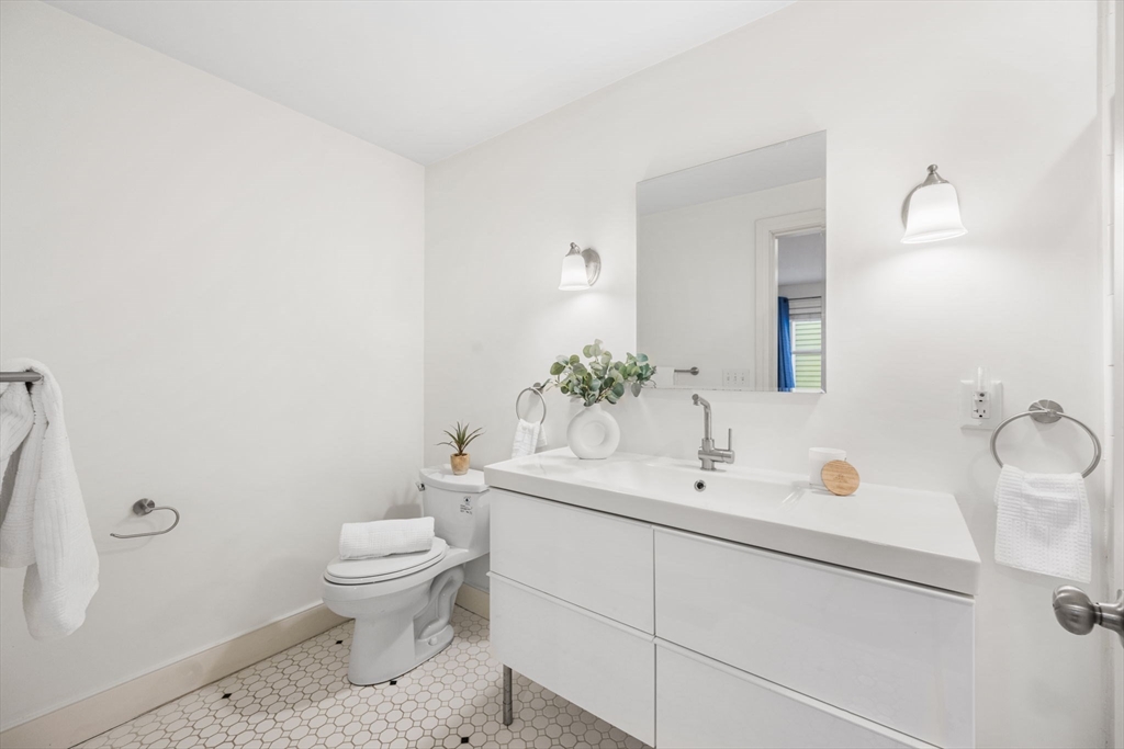 50 Spring Street Cambridge, MA 02141 - Photo 20 of 36 a bathroom with a sink a toilet and a mirror