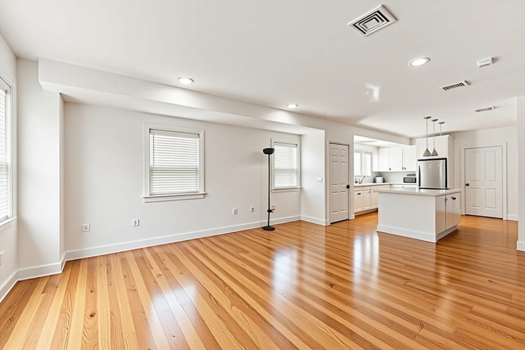 50 Spring Street Cambridge, MA 02141 - Photo 22 of 36 a view of empty room with wooden floor and windows