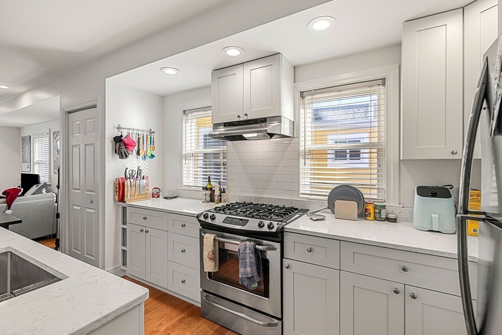 50 Spring Street Cambridge, MA 02141 - Photo 25 of 36 a kitchen with stainless steel appliances granite countertop a sink stove and refrigerator
