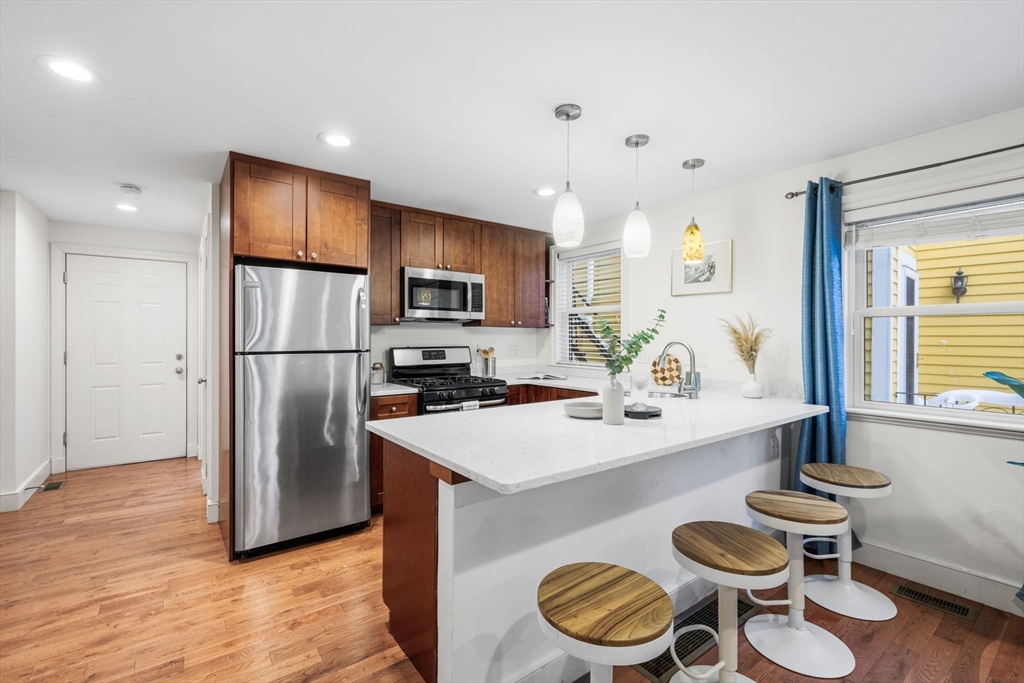 50 Spring Street Cambridge, MA 02141 - Photo 7 of 36 a kitchen with a refrigerator and a stove top oven