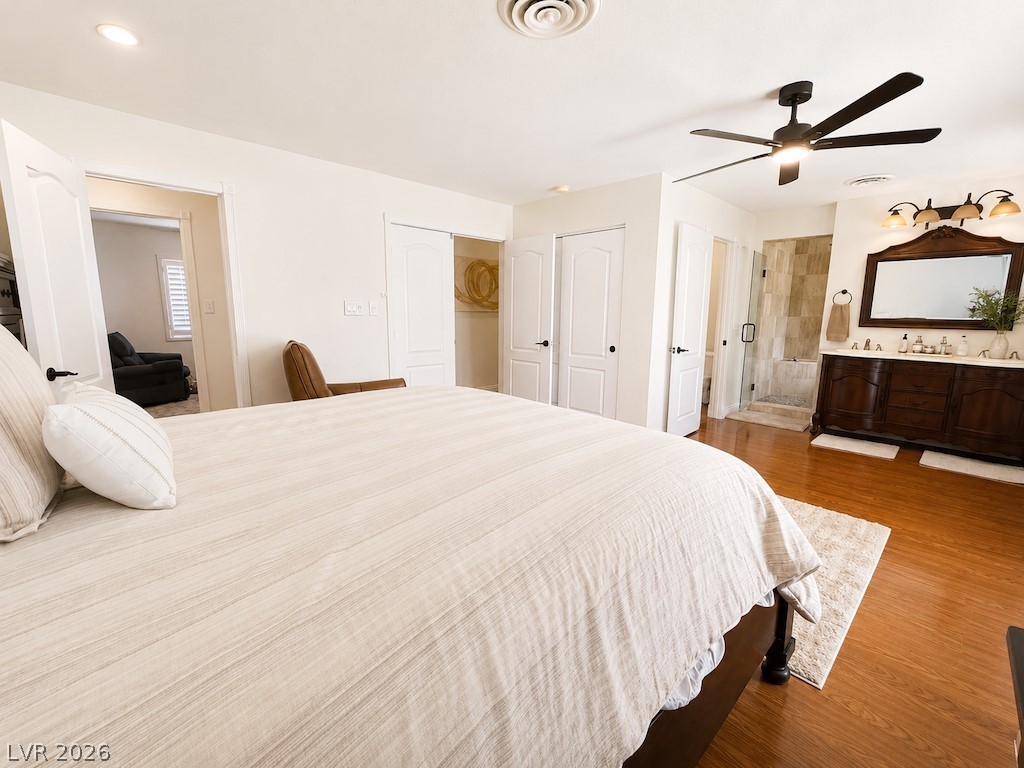 3010 East Viking Road Las Vegas, NV 89121 - Photo 19 of 48 Hardwood floors and a spacious layout define this elegant primary bedroom suite.