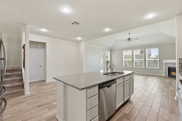 a kitchen with a sink a counter top space and appliances
