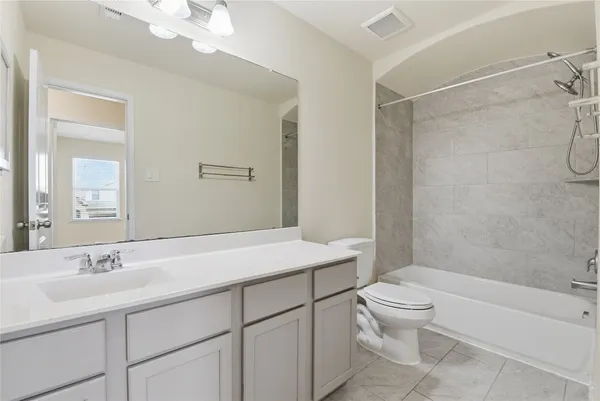 a bathroom with a sink toilet vanity and shower