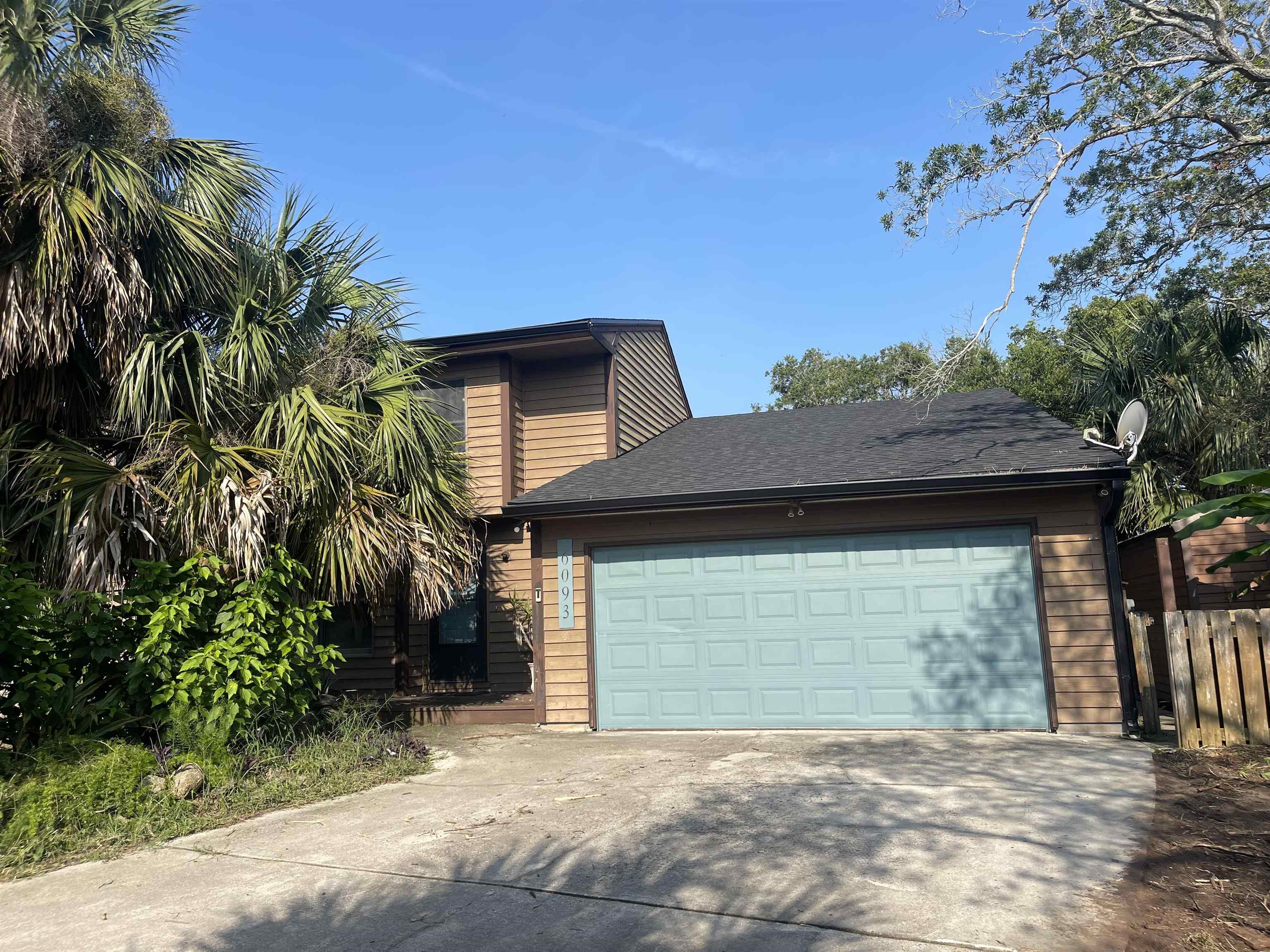 6093 Rojo Road St. Augustine, FL 32080 - Photo 1 of 1 a front view of a house with a garden
