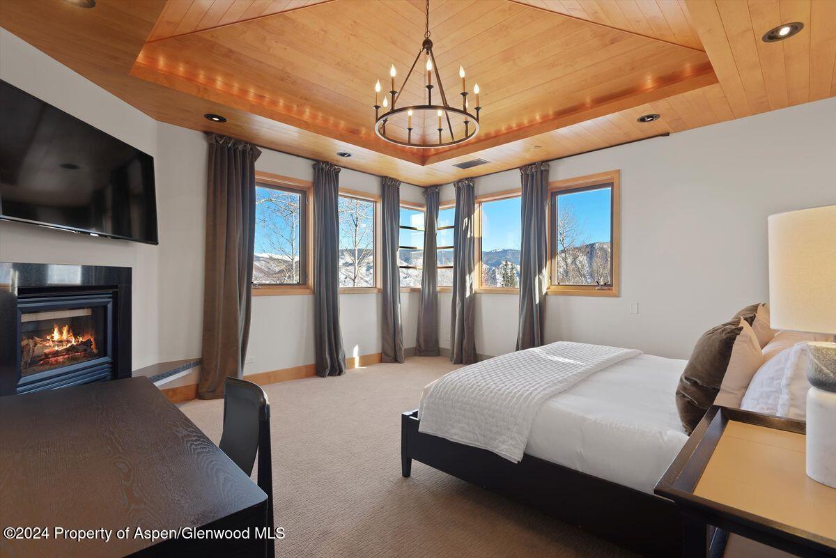 300 Eagle Pines Drive Aspen, CO 81611 - Photo 28 of 47 a bedroom with a bed and a flat screen tv