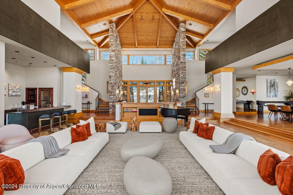 300 Eagle Pines Drive Aspen, CO 81611 - Photo 8 of 47 a living room with furniture and a chandelier