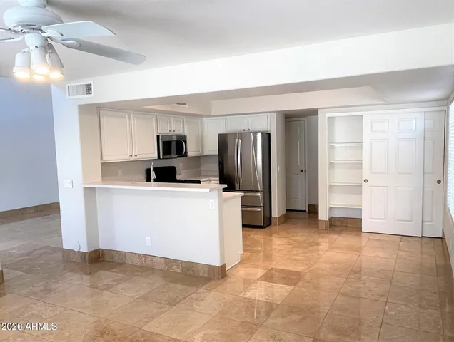 a view of a kitchen with refrigerator and microwave
