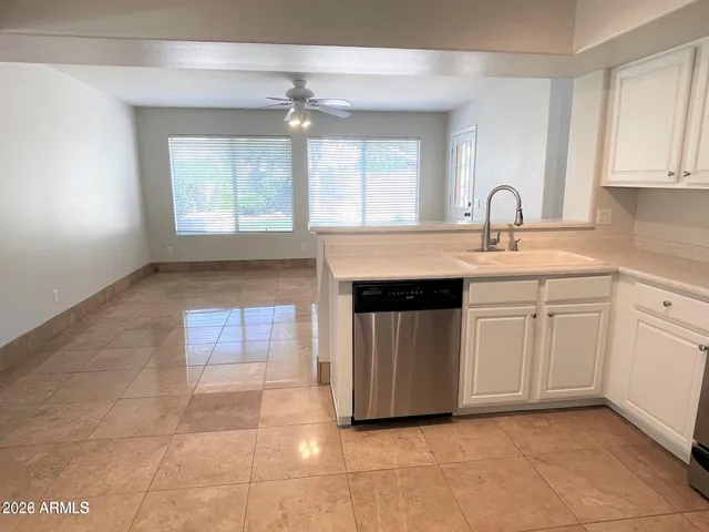 a kitchen with sink and cabinets