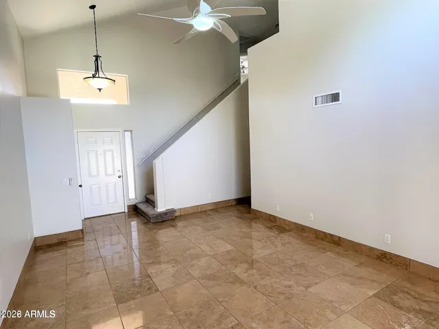 a view of a room with a ceiling fan