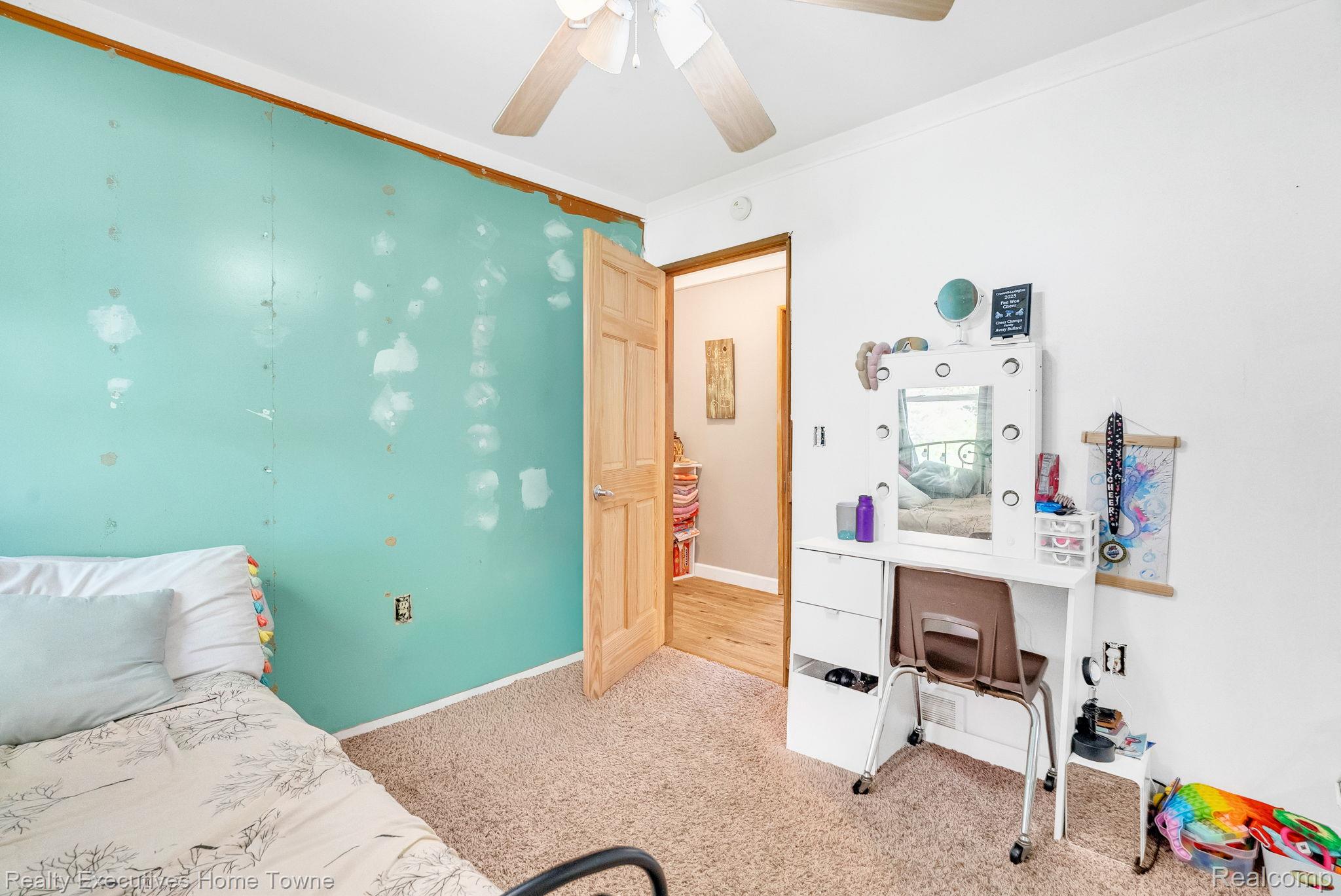 6560 Roach Road Lexington, MI 48450 - Photo 23 of 36 Carpeted room featuring a ceiling fan, a light wood door, and a light wood door frame