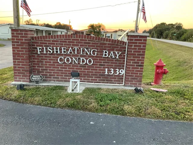 a front view of a house with a garden and trees