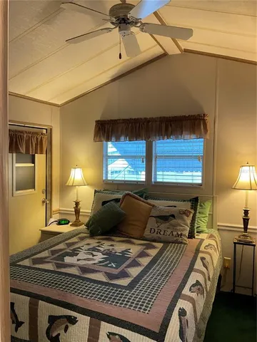 a bedroom with a bed a window and dresser