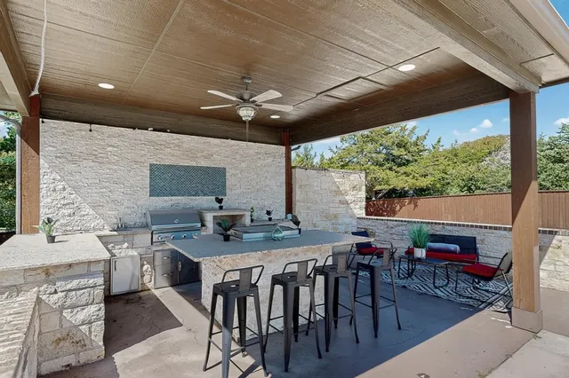 a living room with furniture and floor to ceiling window