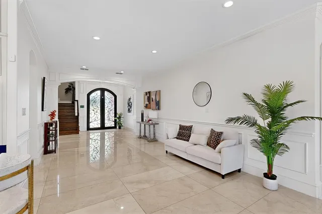 a living room with furniture potted plant and a large window