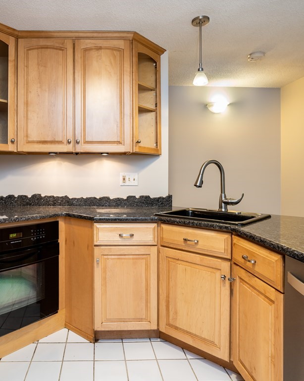 30 Mattoon Street, Unit 3 Springfield, MA 01105 - Photo 17 of 38 a kitchen with granite countertop white cabinets and white appliances
