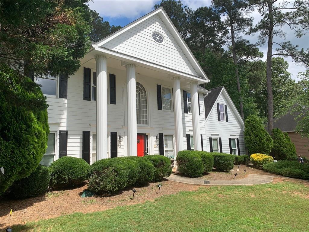 3216 Harvester Woods Road Decatur, GA 30034 - Photo 1 of 1 a front view of a house with yard and green space
