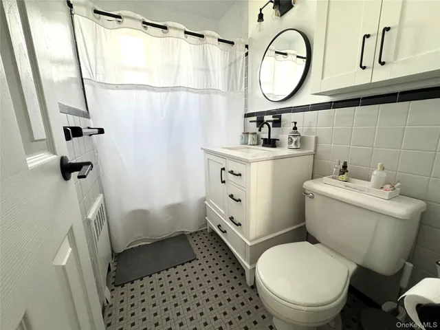 a bathroom with a toilet a sink and a mirror