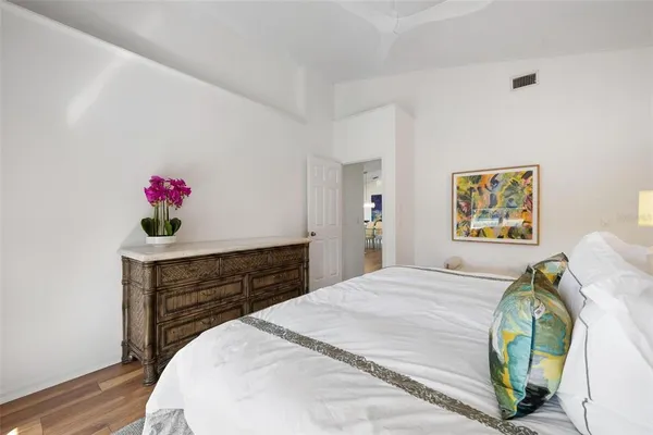a bedroom with a bed and lamp