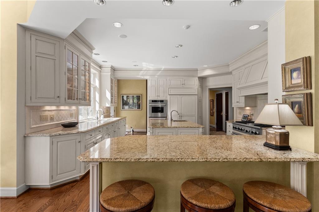 282 Justabout Road Venetia, PA 15367 - Photo 17 of 50 a kitchen with granite countertop a sink a stove cabinets and wooden floor