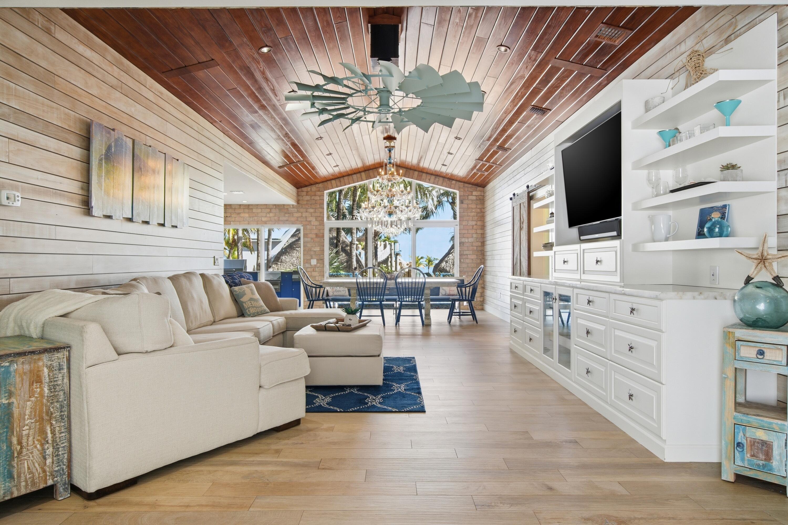 101 Oleander Circle Key Largo, FL 33037 - Photo 11 of 126 a living room with furniture a chandelier and a flat screen tv