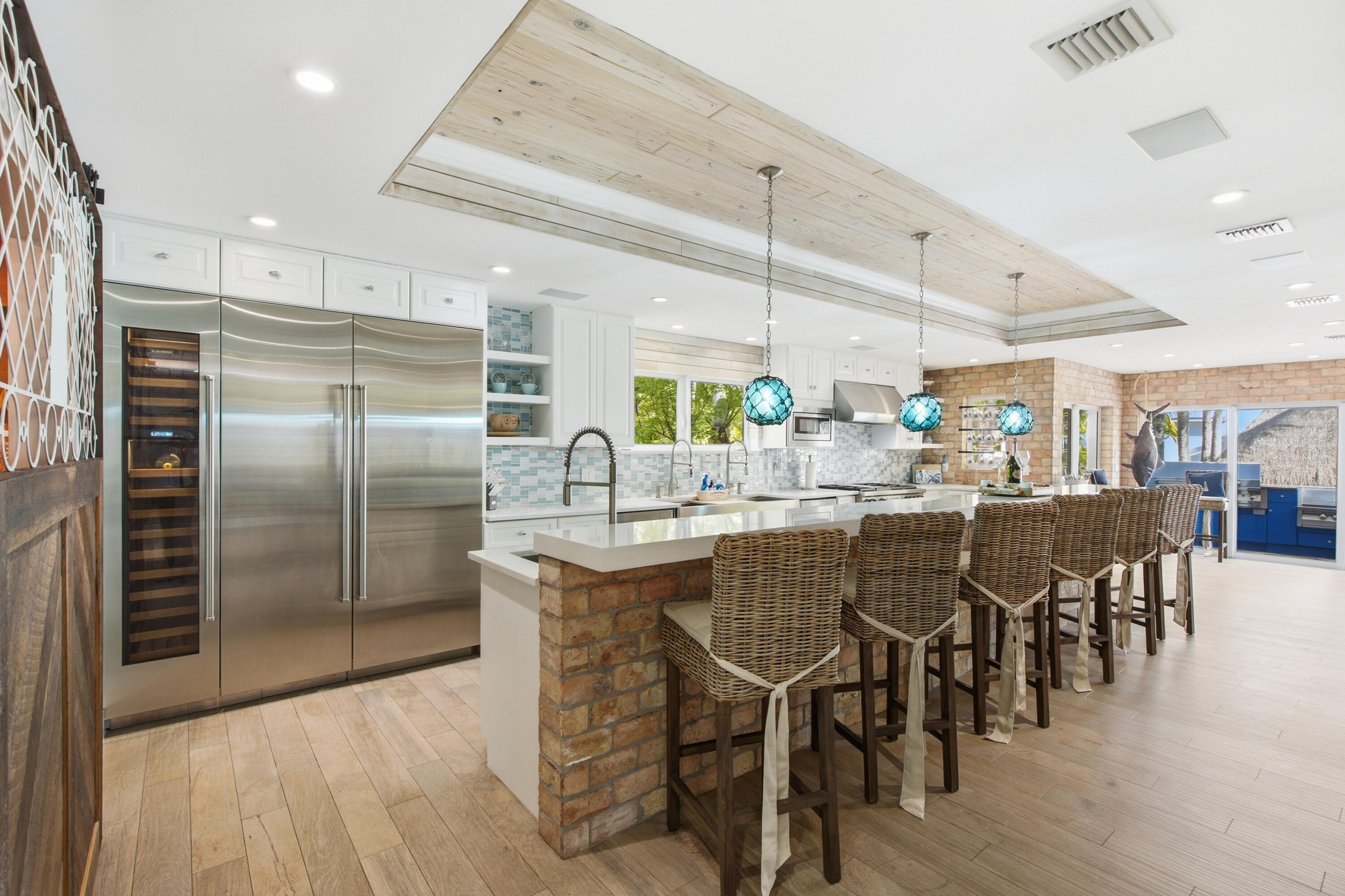101 Oleander Circle Key Largo, FL 33037 - Photo 21 of 126 a kitchen with stainless steel appliances granite countertop a dining table chairs sink and wooden floor
