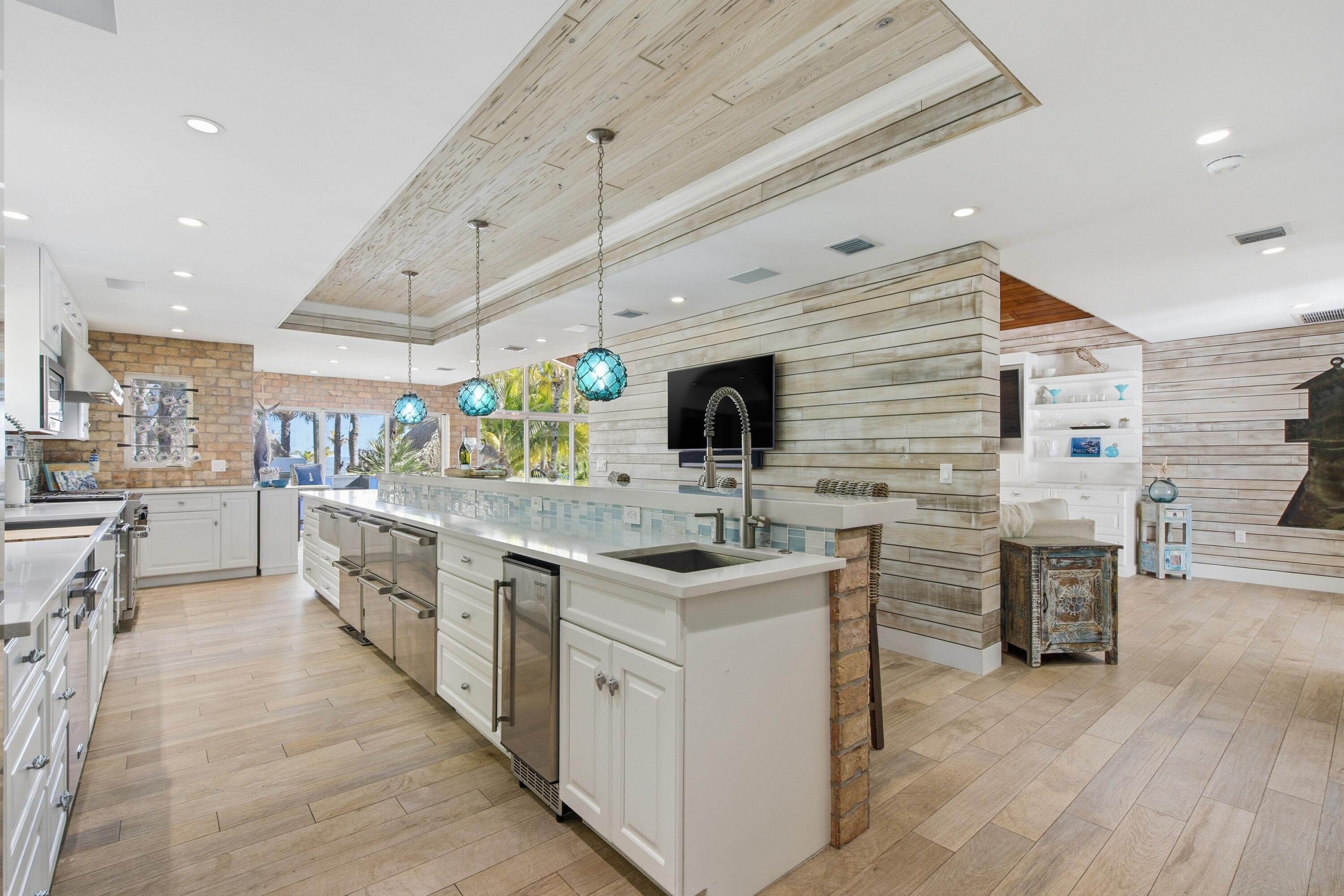 101 Oleander Circle Key Largo, FL 33037 - Photo 22 of 126 a kitchen with stainless steel appliances kitchen island granite countertop a stove and a sink