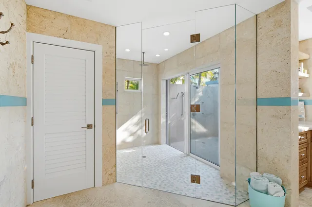 a spacious bedroom with a bed and a lamp