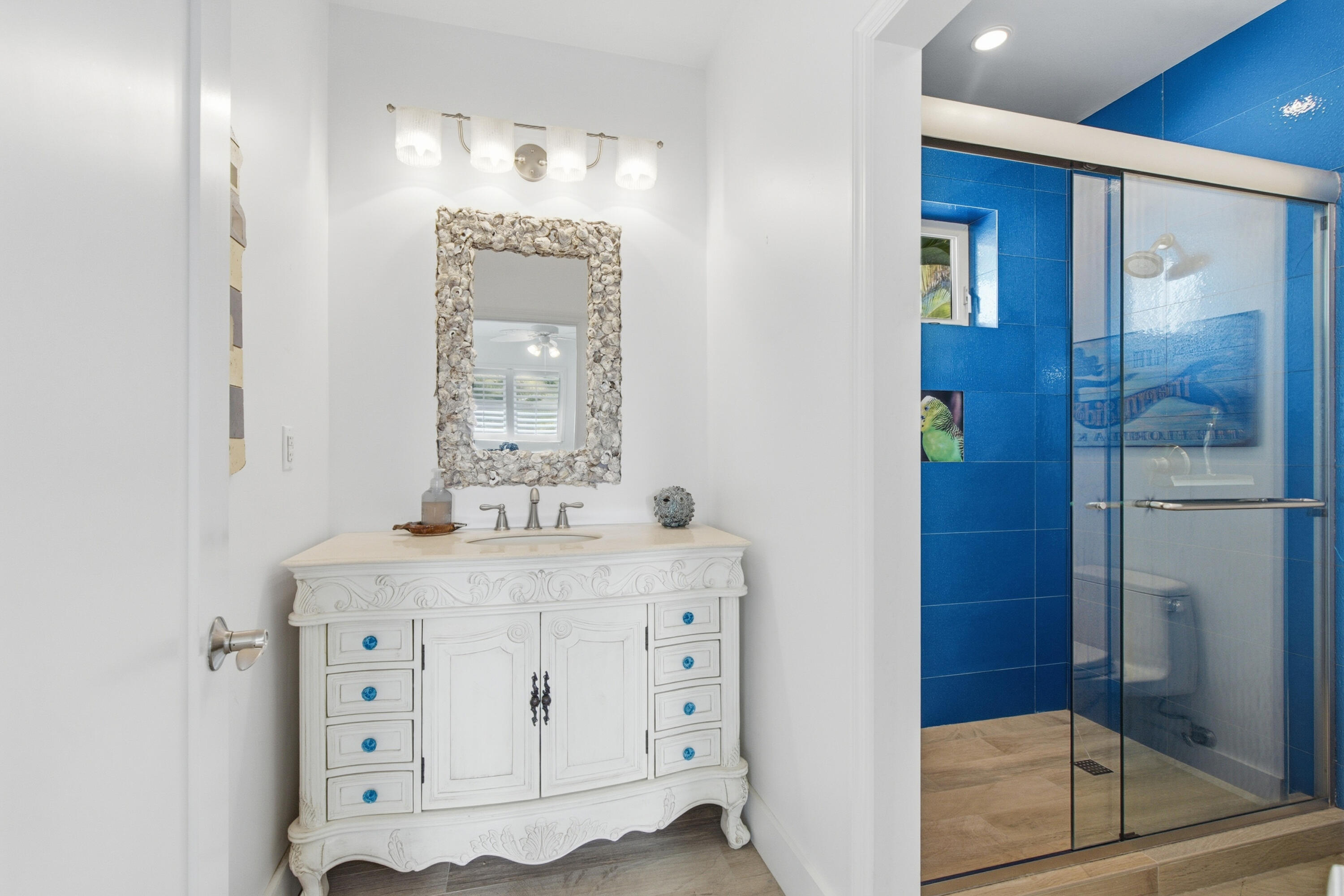 101 Oleander Circle Key Largo, FL 33037 - Photo 44 of 126 a bathroom with a granite countertop sink a mirror a vanity and a shower