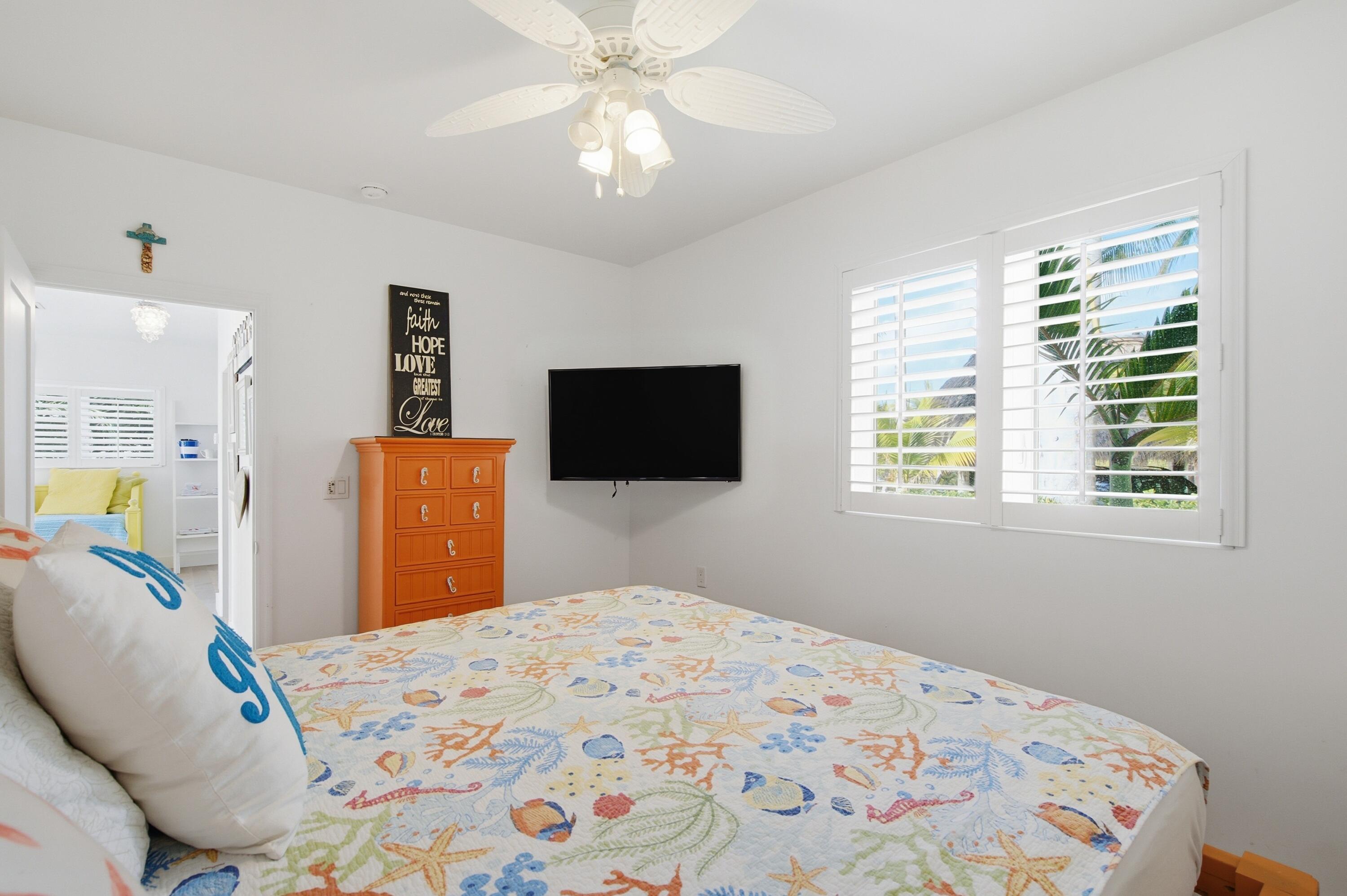 101 Oleander Circle Key Largo, FL 33037 - Photo 46 of 126 a bedroom with a bed dresser and a window