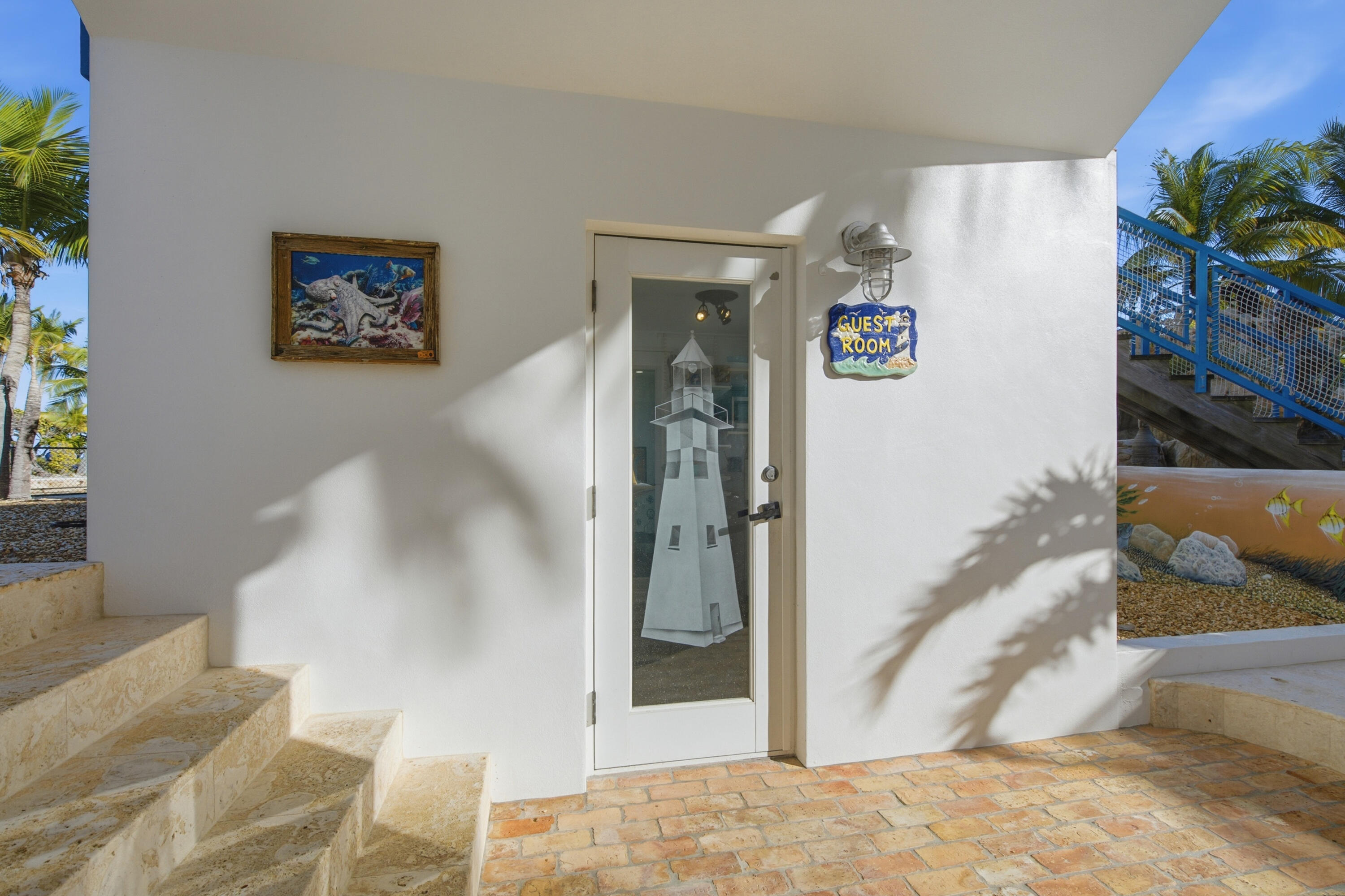 101 Oleander Circle Key Largo, FL 33037 - Photo 73 of 126 a view of a hallway with paintings on the wall