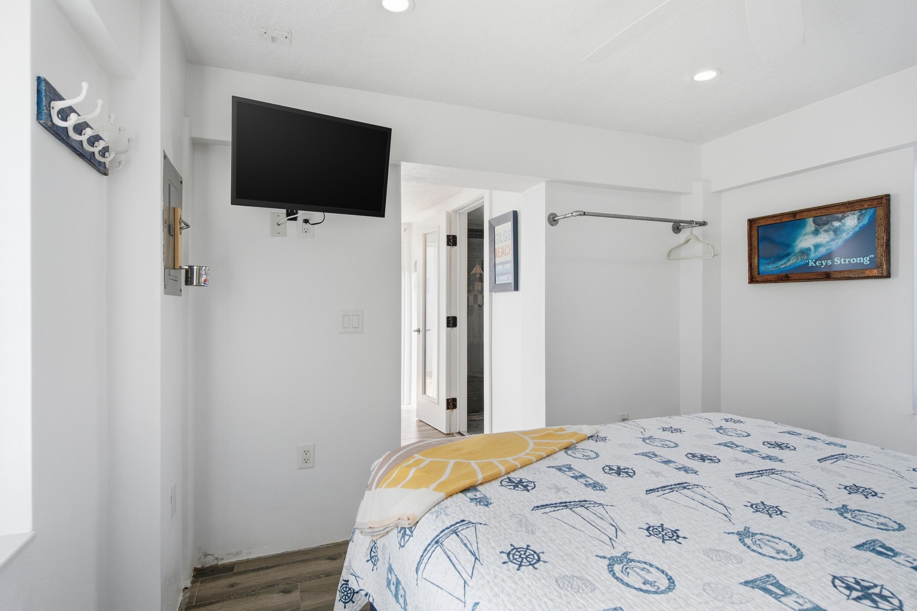 101 Oleander Circle Key Largo, FL 33037 - Photo 75 of 126 a bedroom with a bed and a flat screen tv