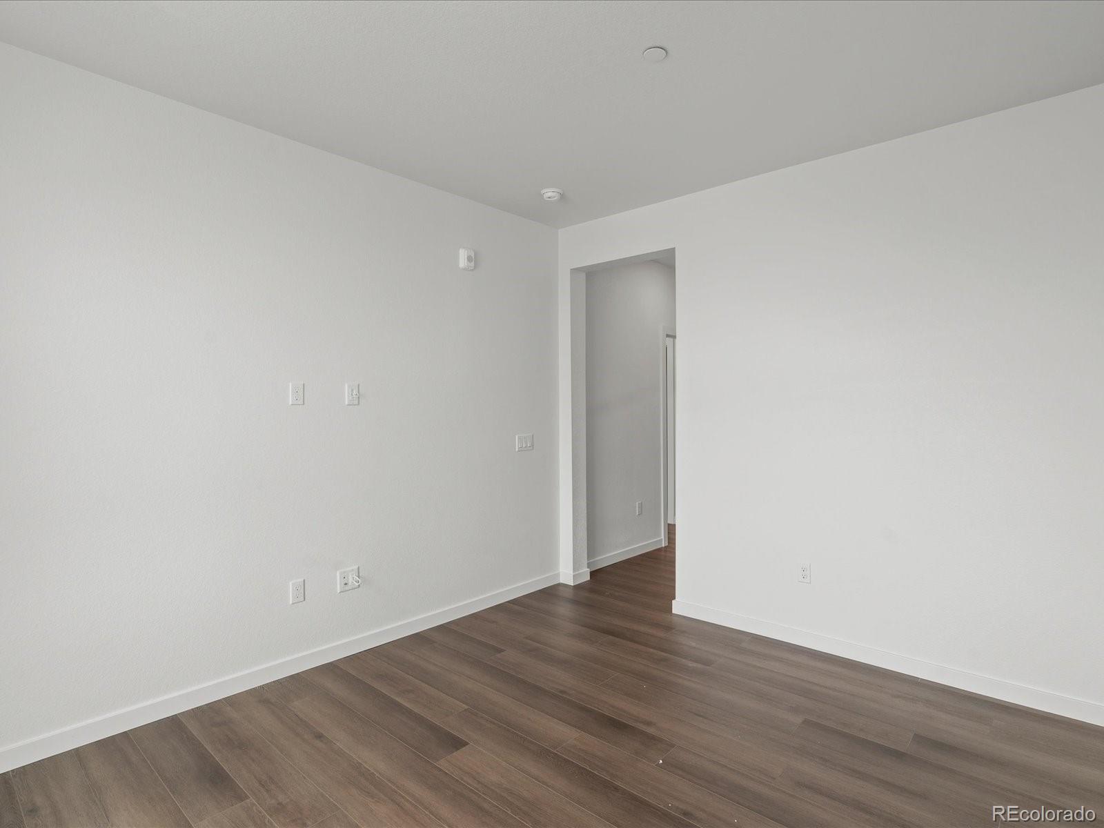 6153 North Ceylon Street, Unit 304 Denver, CO 80249 - Photo 17 of 24 a view of an empty room with wooden floor