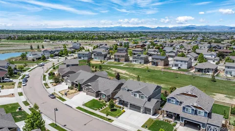 an aerial view of lake and residential houses with outdoor space