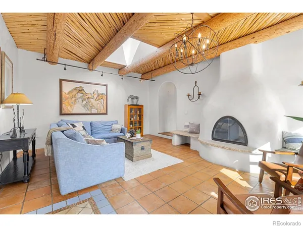 a living room with furniture a rug and a chandelier