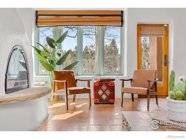 a living room with furniture and a floor to ceiling window
