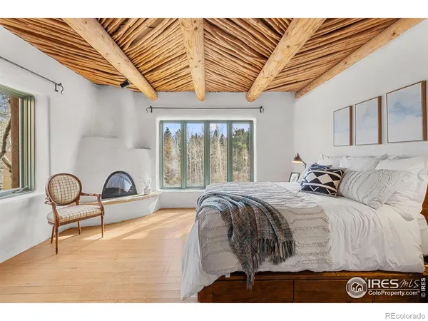 a bed sitting in a bedroom next to a window