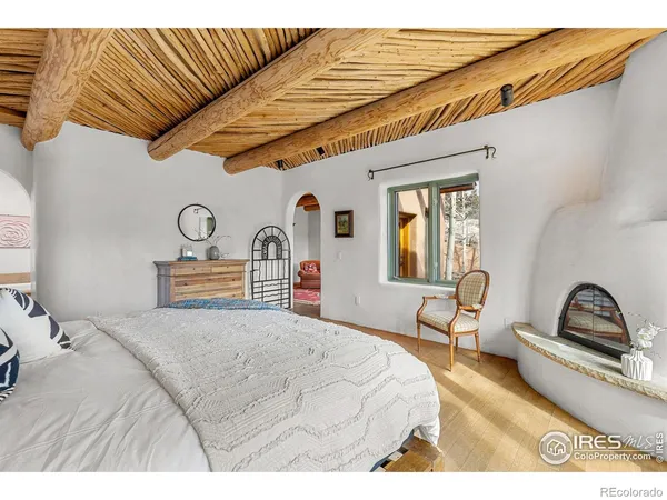 a bedroom with a bed a dresser and window