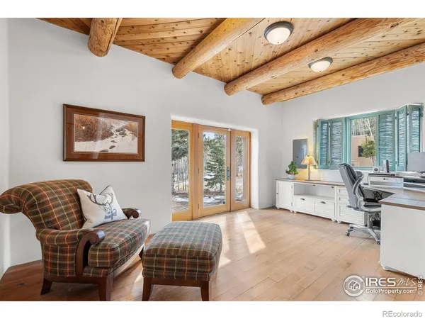 a bedroom with furniture and a large window