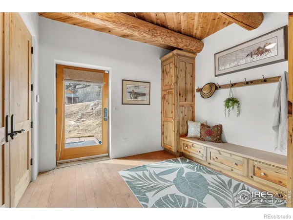 a view of an entryway with wooden floor