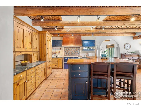 a kitchen with stainless steel appliances granite countertop a stove and cabinets