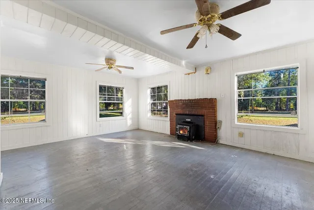 a view of empty room with fireplace and window