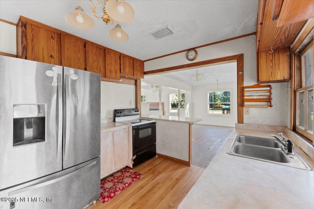 478 Harris Road Lake City, FL 32055 - Photo 6 of 43 a kitchen with granite countertop a sink stainless steel appliances and cabinets