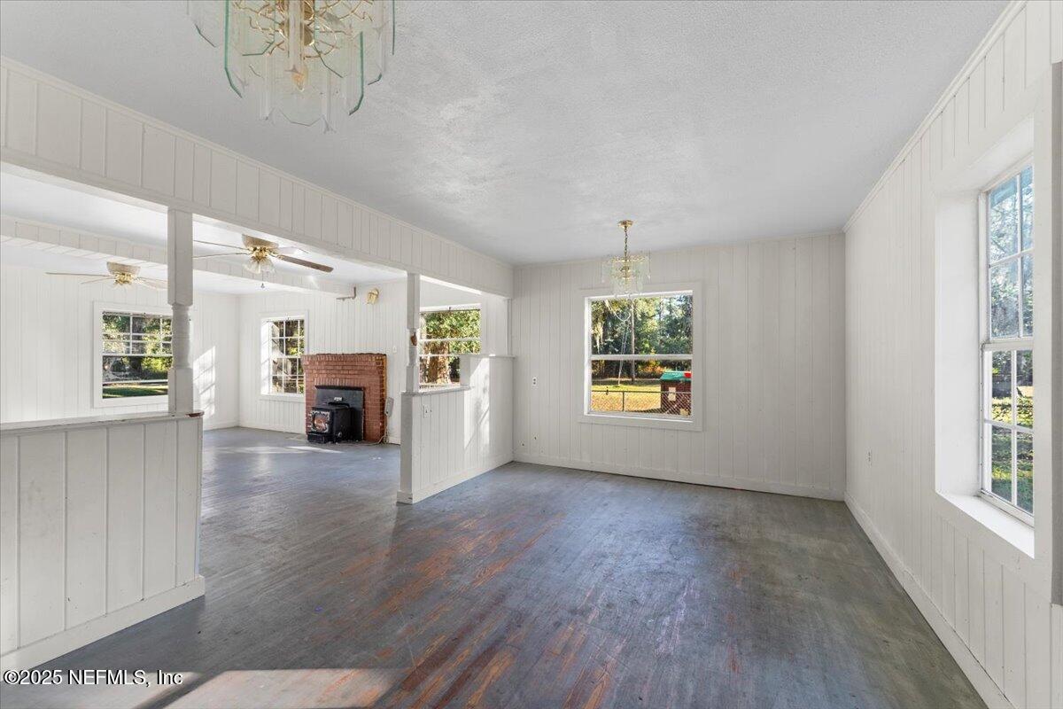 478 Harris Road Lake City, FL 32055 - Photo 9 of 43 a view of an empty room with a window and wooden floor
